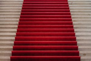 A red carpet covers brad stairs at a museam in Geneva, Switzerland. It looks inviting.