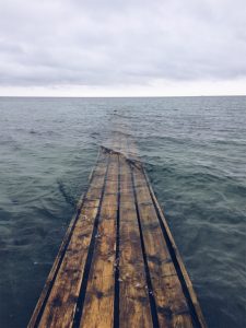 A wood platform on the beach which is already under water.