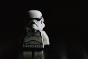 LEGO stormtrooper an a black background. He looks quite shady as he is half hidden in the shade.