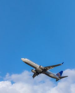 Plane take off in front of blue sky.